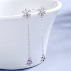 Women’s earrings with sparkling snowflake pendant and chain embellishment