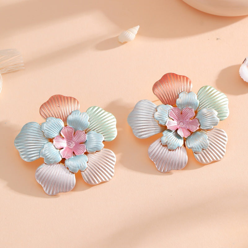 Ladies' flower earrings with intricate design and glossy accents