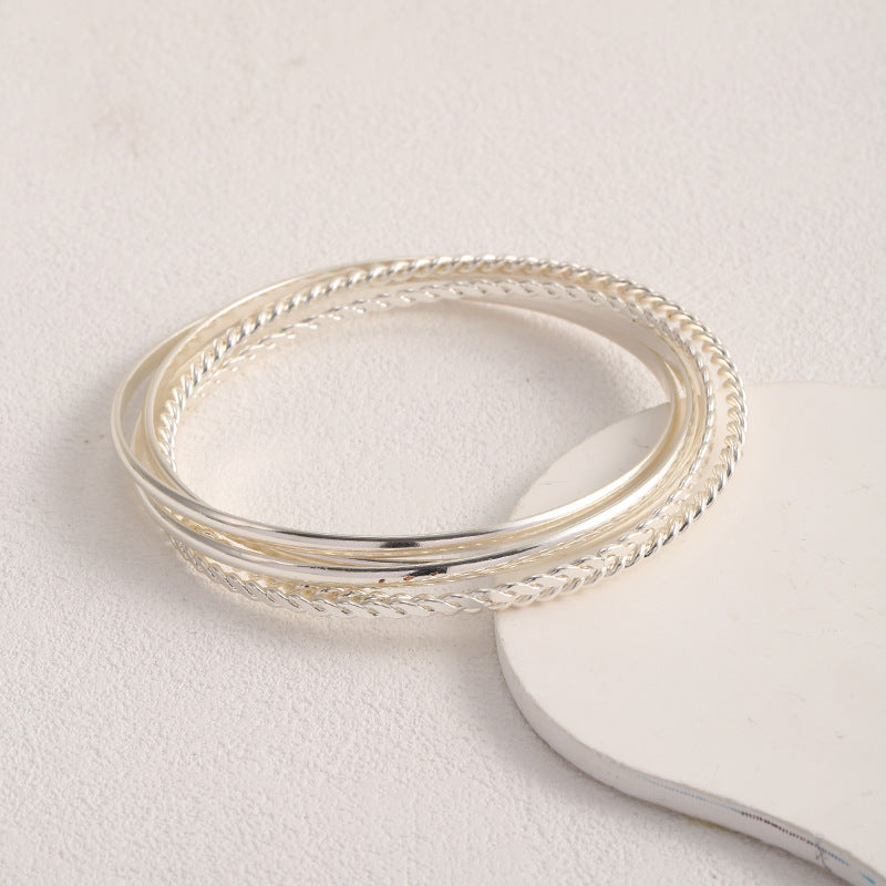 Women's bangle set with elaborate, braided and simple designs