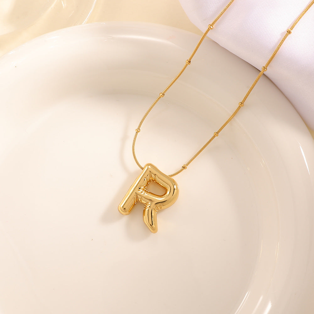 Women's necklace with curved letter pendant