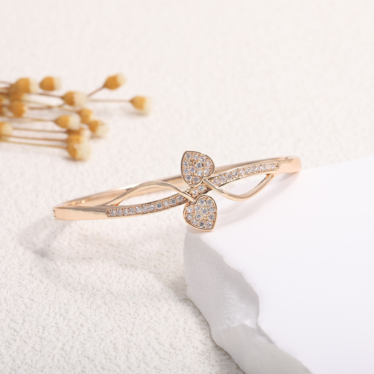 Women's bangle with elegant infinity pattern and sparkling zirconia