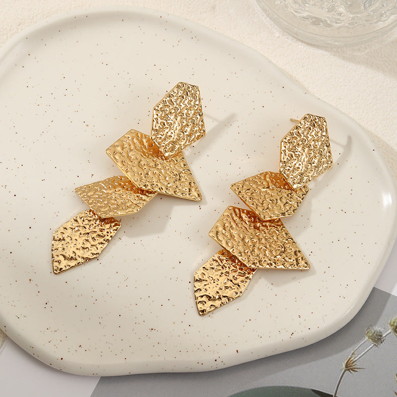Women's elegant earrings with rustic, folded design