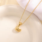 Women's necklace with curved letter pendant