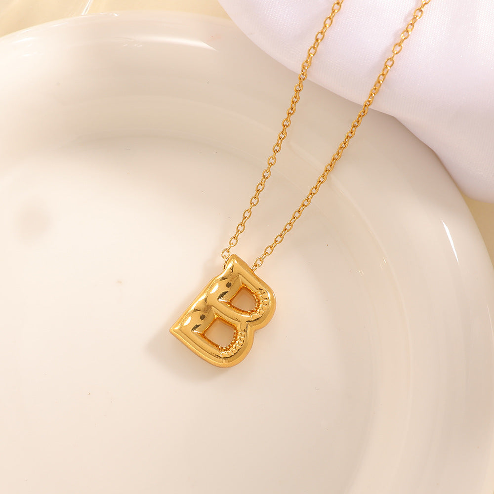 Women's necklace with curved letter pendant