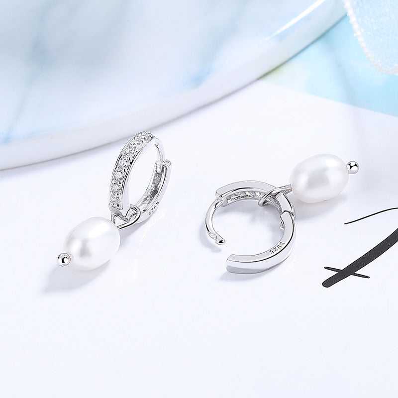 Ladies earrings with elegant zirconia decorations and pearl pendants