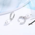Ladies earrings with elegant zirconia decorations and pearl pendants