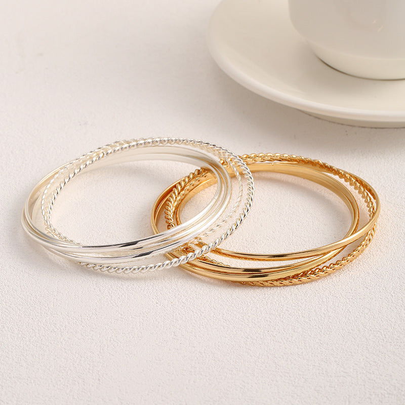 Women's bangle set with elaborate, braided and simple designs