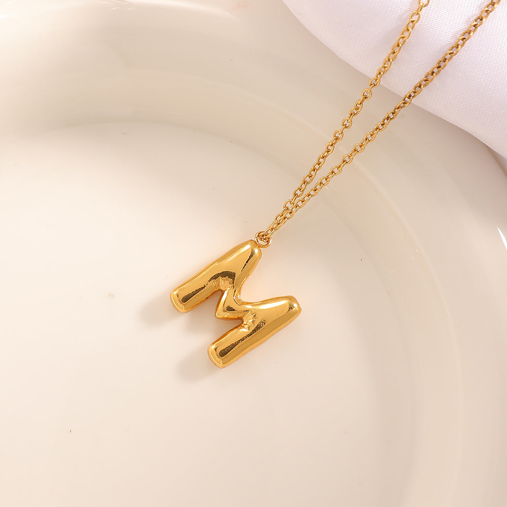 Women's necklace with curved letter pendant