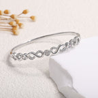 Ladies bracelet with elaborate infinity symbol and sparkling zirconia