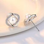 Ladies earrings with artistic pearl design and sparkling zirconia