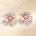 Women’s metal flower earrings with sparkling red accents