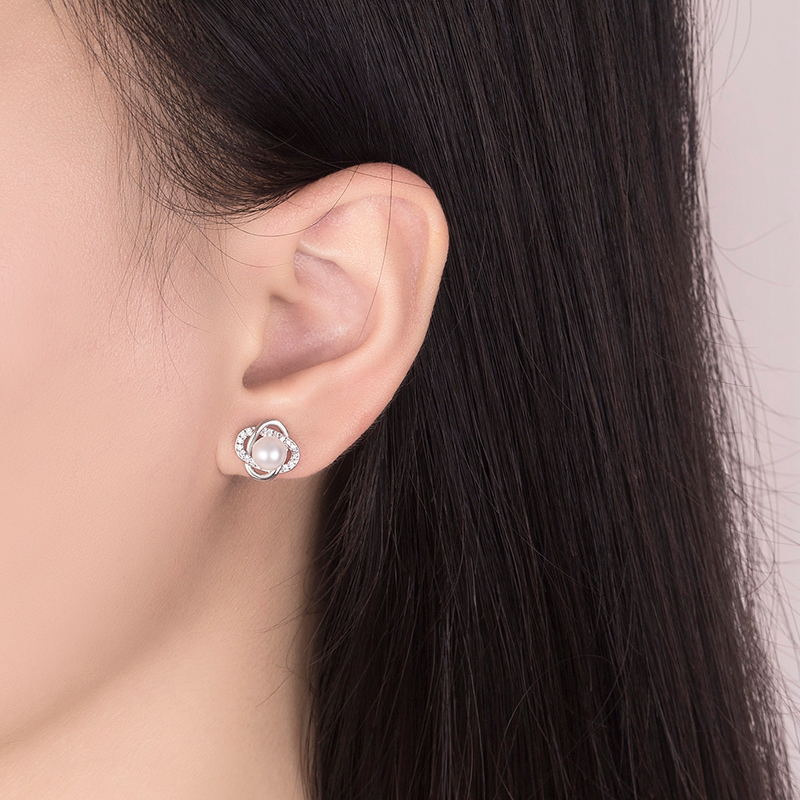 Ladies earrings with artistic pearl design and sparkling zirconia