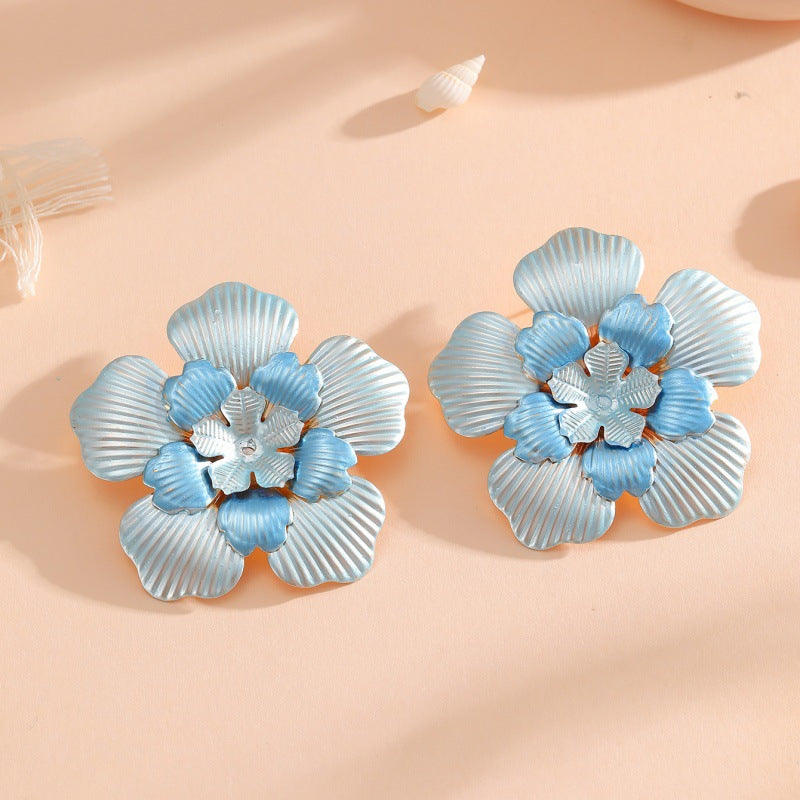 Ladies' flower earrings with intricate design and glossy accents