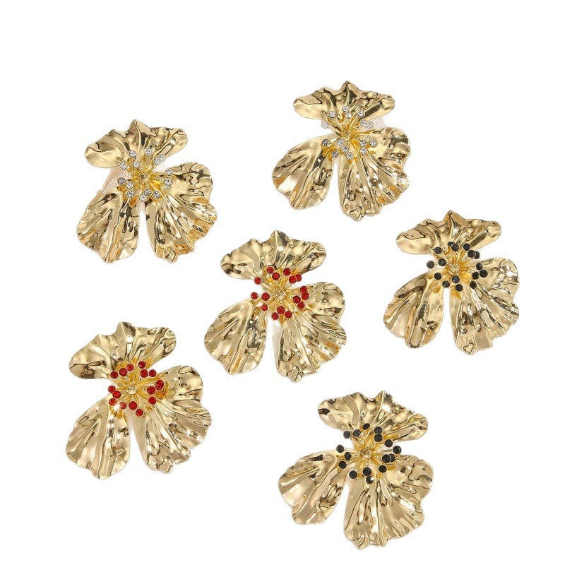 Women’s metal flower earrings with sparkling red accents