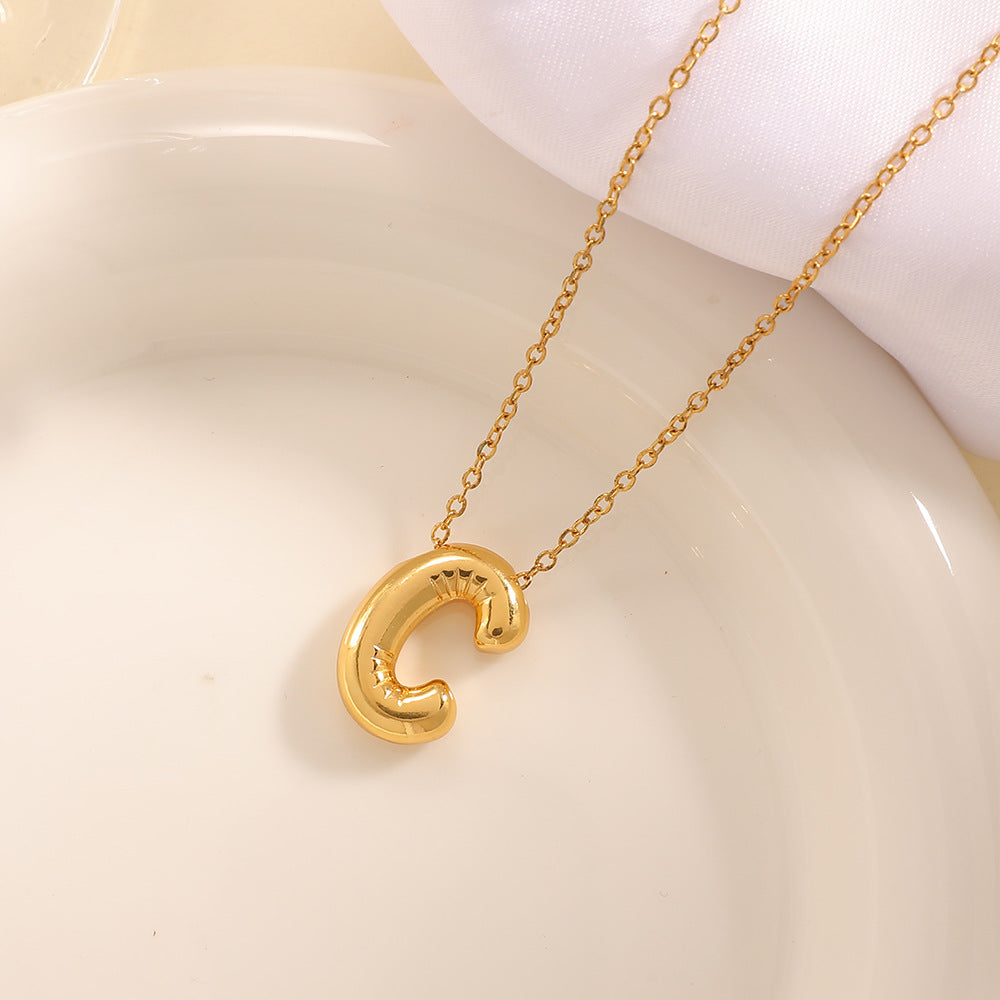 Women's necklace with curved letter pendant