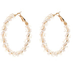 Ladies hoop earrings with luxurious pearl accents and elegant, twisted design