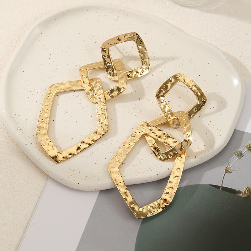 Women's elegant earrings with rustic, folded design