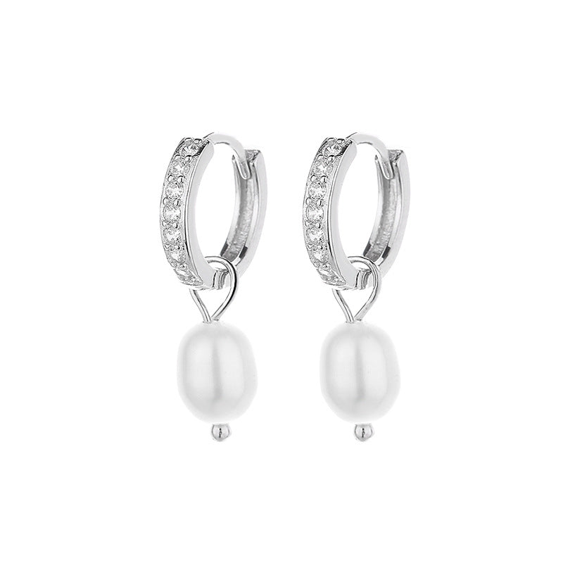 Ladies earrings with elegant zirconia decorations and pearl pendants