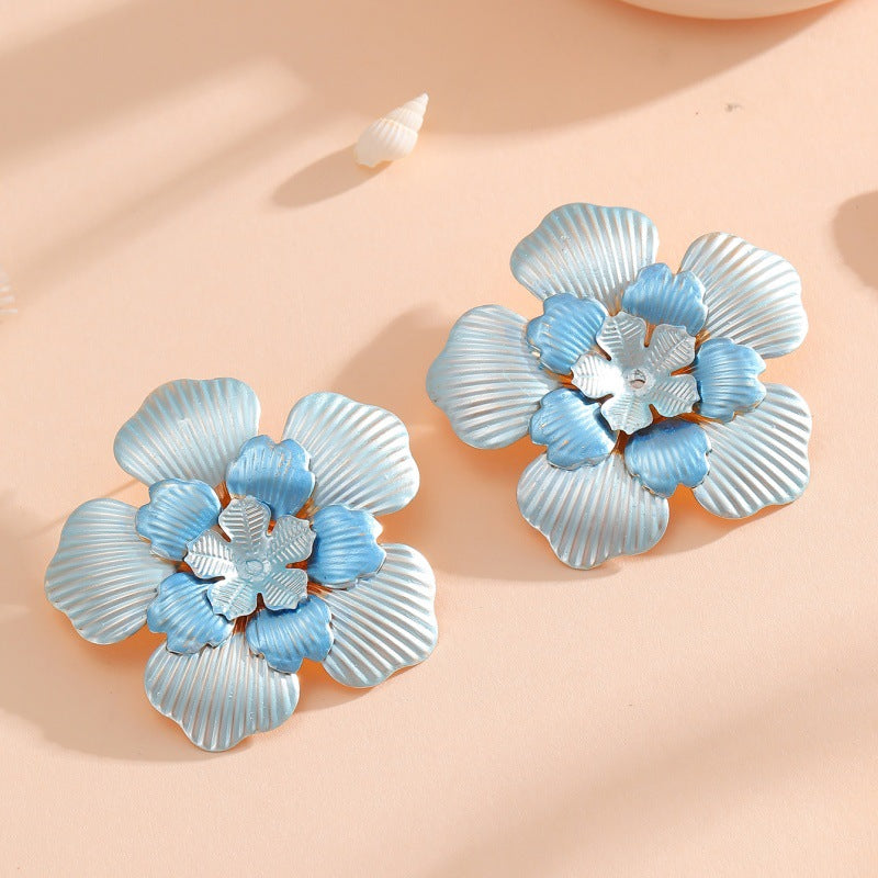 Ladies' flower earrings with intricate design and glossy accents