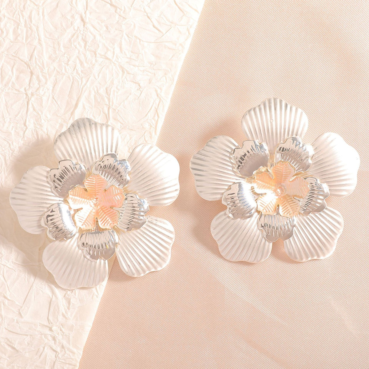 Ladies' flower earrings with intricate design and glossy accents