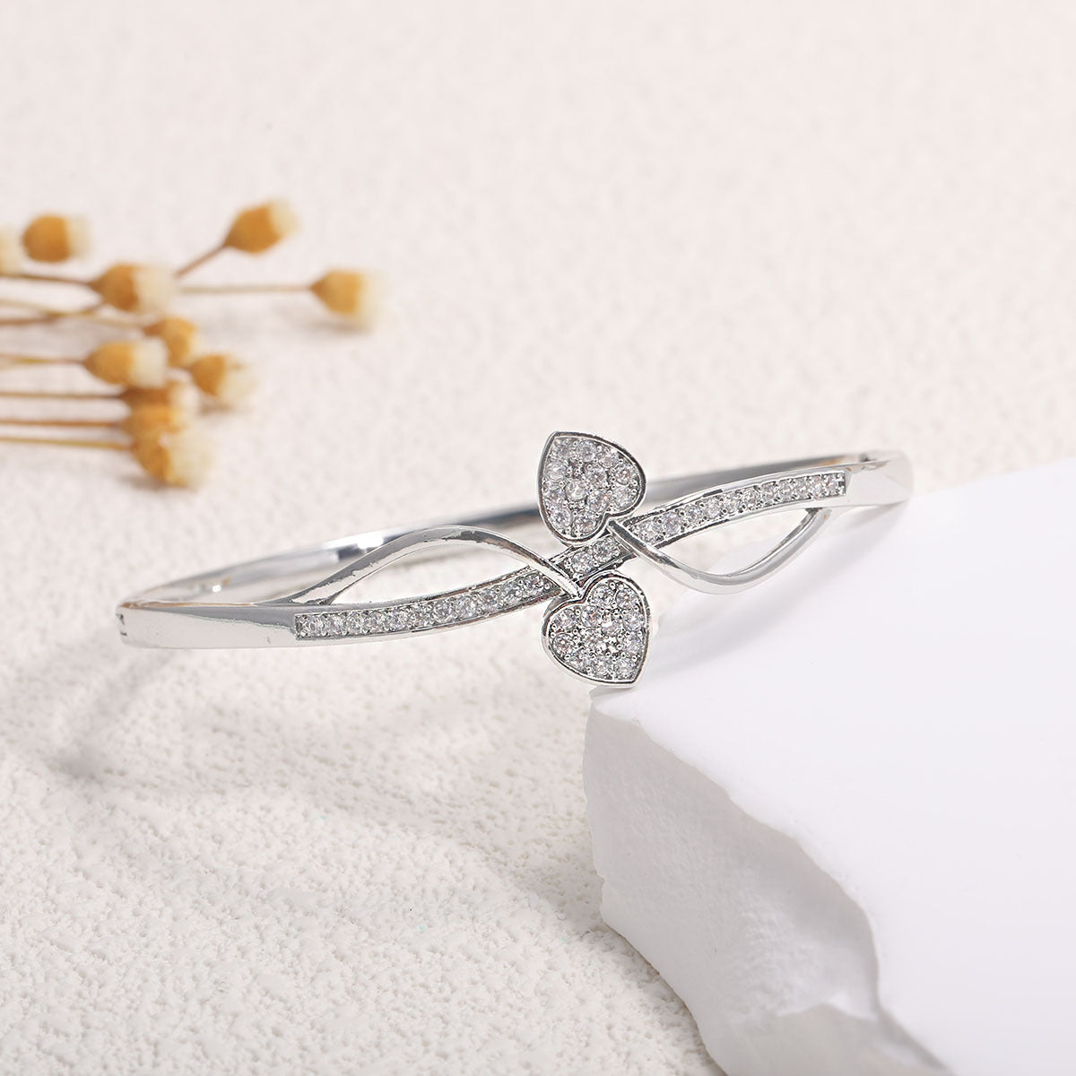 Women's bangle with elegant infinity pattern and sparkling zirconia