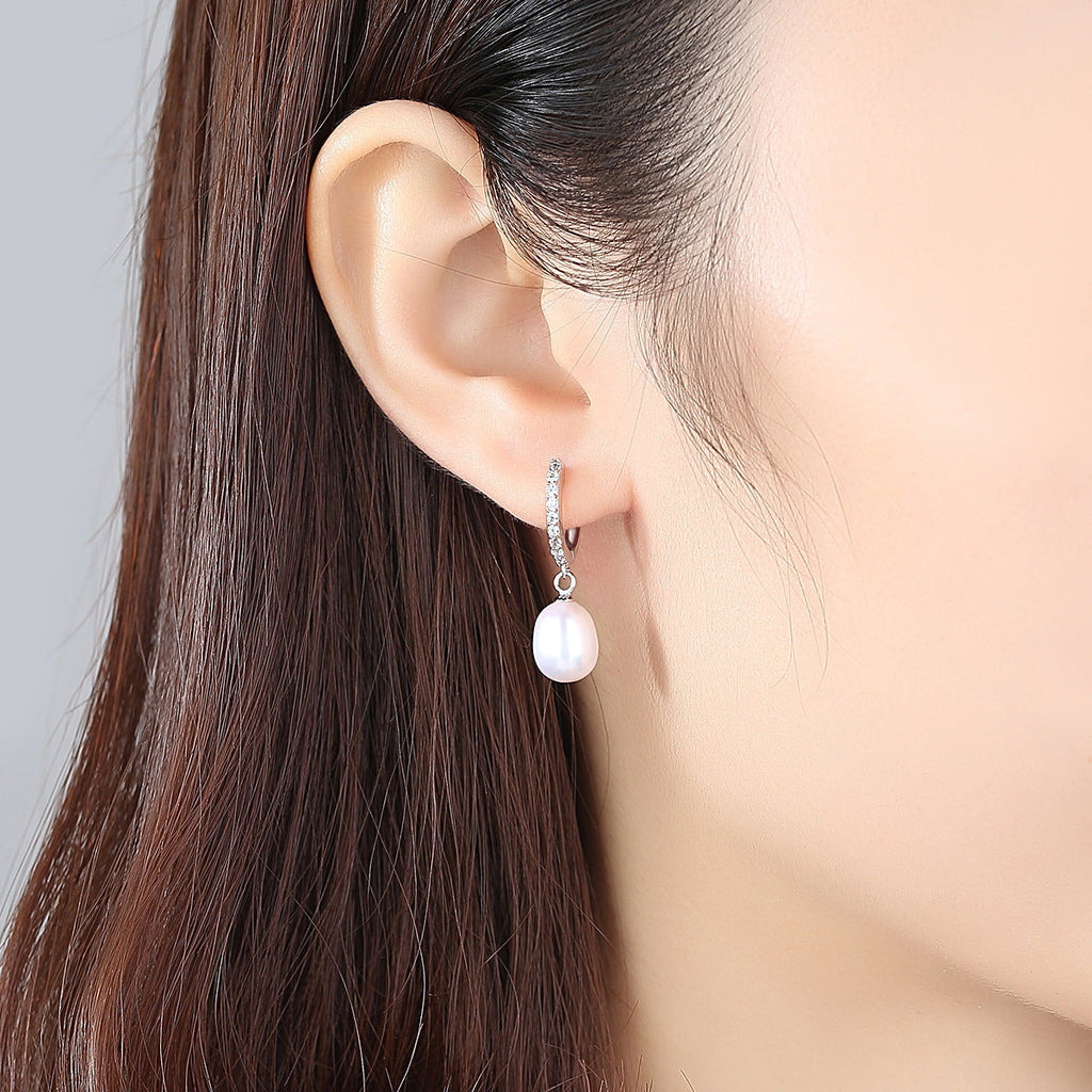 Ladies earrings with elegant zirconia decorations and pearl pendants