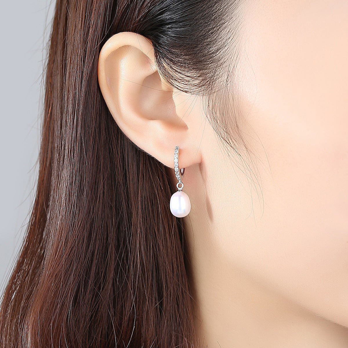 Ladies earrings with elegant zirconia decorations and pearl pendants
