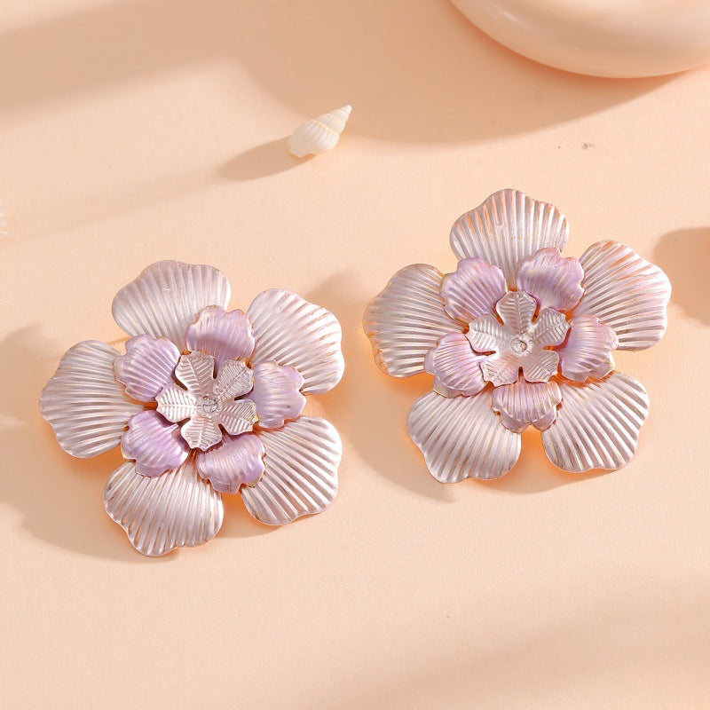 Ladies' flower earrings with intricate design and glossy accents