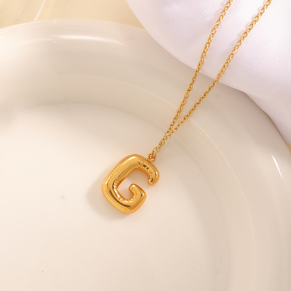 Women's necklace with curved letter pendant