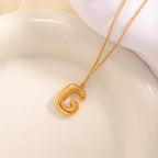 Women's necklace with curved letter pendant