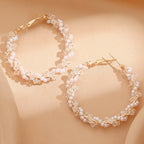 Ladies hoop earrings with luxurious pearl accents and elegant, twisted design