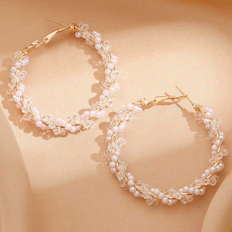 Ladies hoop earrings with luxurious pearl accents and elegant, twisted design