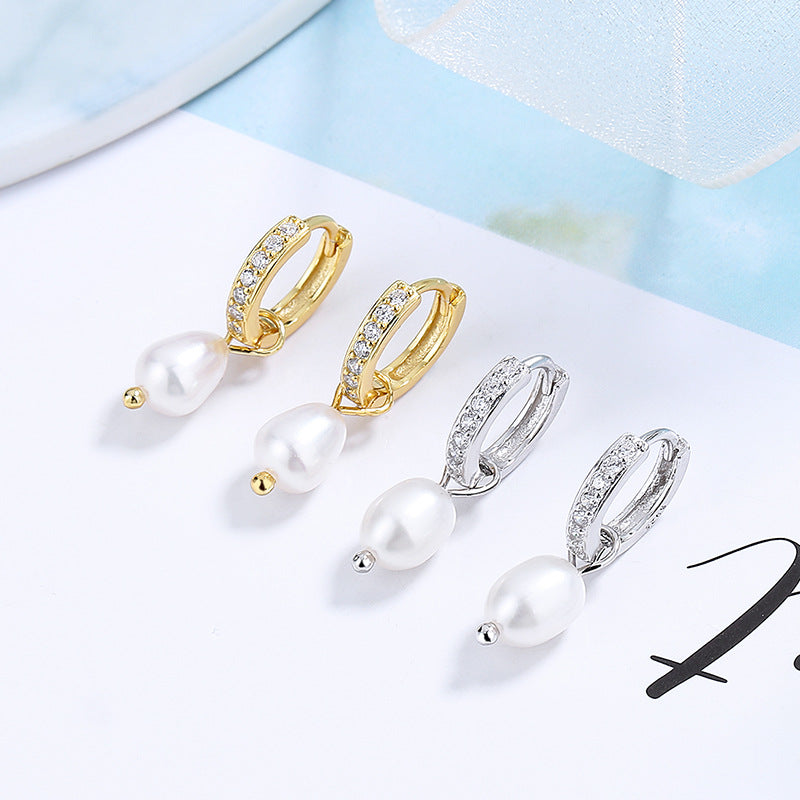 Ladies earrings with elegant zirconia decorations and pearl pendants