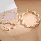 Ladies hoop earrings with luxurious pearl accents and elegant, twisted design