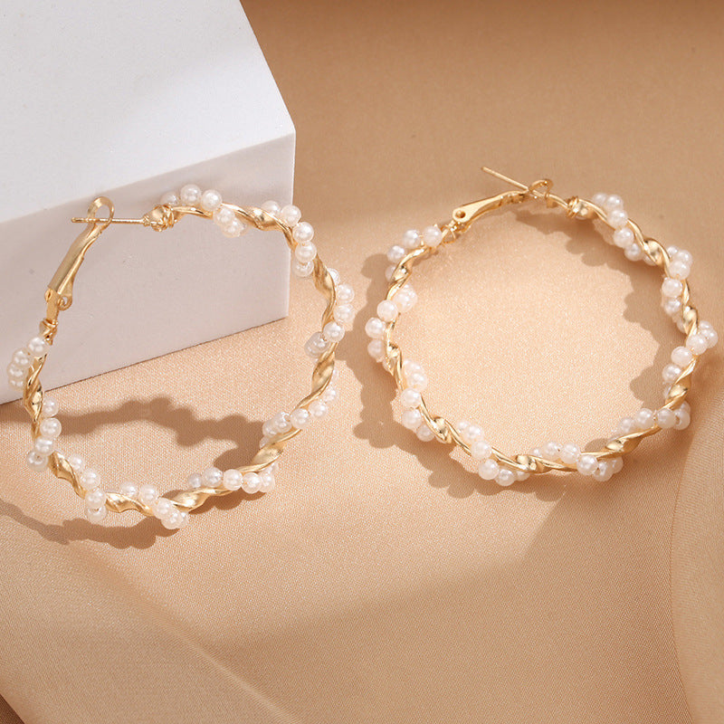 Ladies hoop earrings with luxurious pearl accents and elegant, twisted design