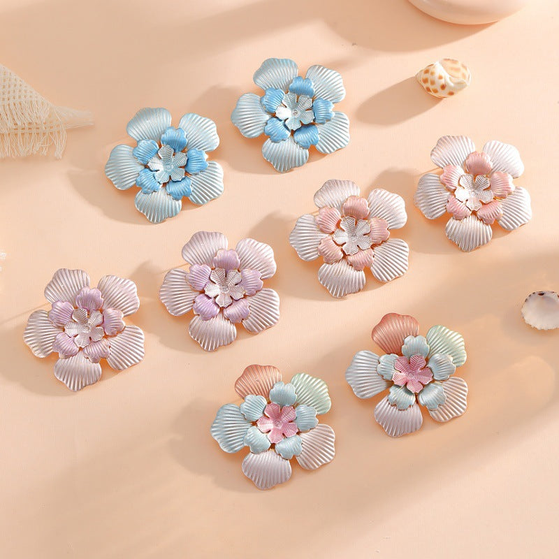 Ladies' flower earrings with intricate design and glossy accents