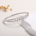 Women's bangle with elegant infinity pattern and sparkling zirconia