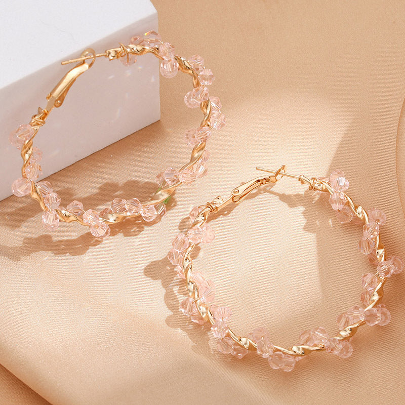 Ladies hoop earrings with luxurious pearl accents and elegant, twisted design