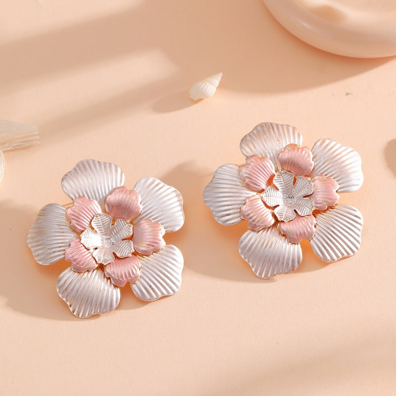 Ladies' flower earrings with intricate design and glossy accents
