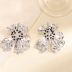 Women’s metal flower earrings with sparkling red accents