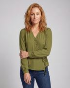 Women's elegant blouse shirt with modern wrap design and fine button details - upper body view