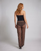 Women Elegant Top with trendy Neck Jewelry and wide, patterned Pants All Fashion - back view