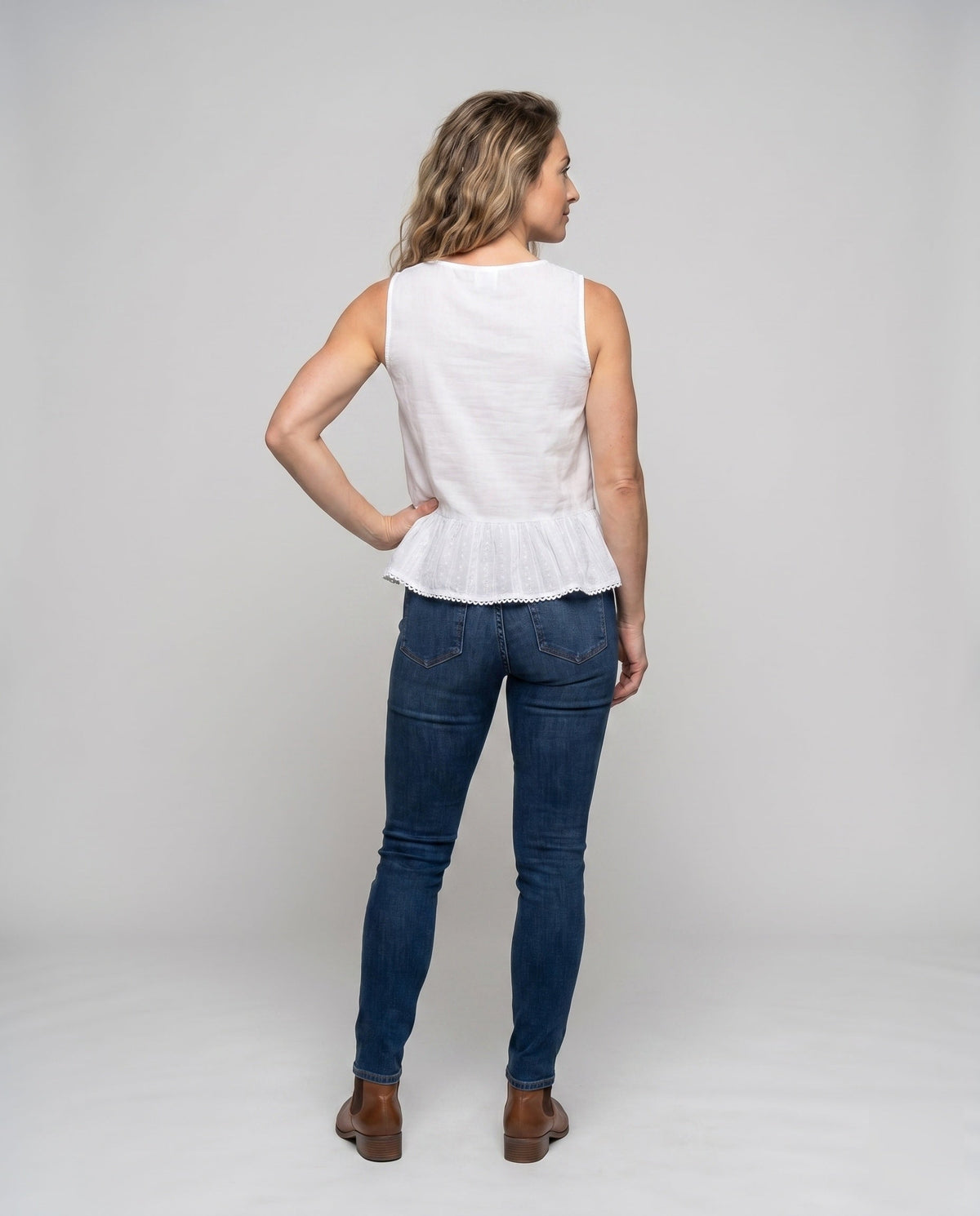 Women's airy blouse top with playful ruffle - back view