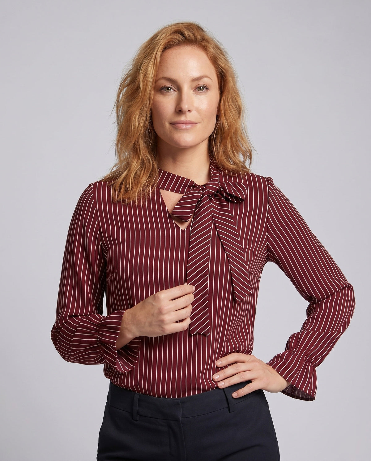 Women's blouse shirt with elegant bow tie and striped pattern - upper body view