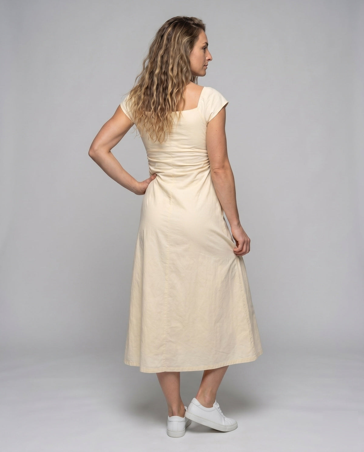 Women's dress with elegant ruffles and figure-hugging cut - back view