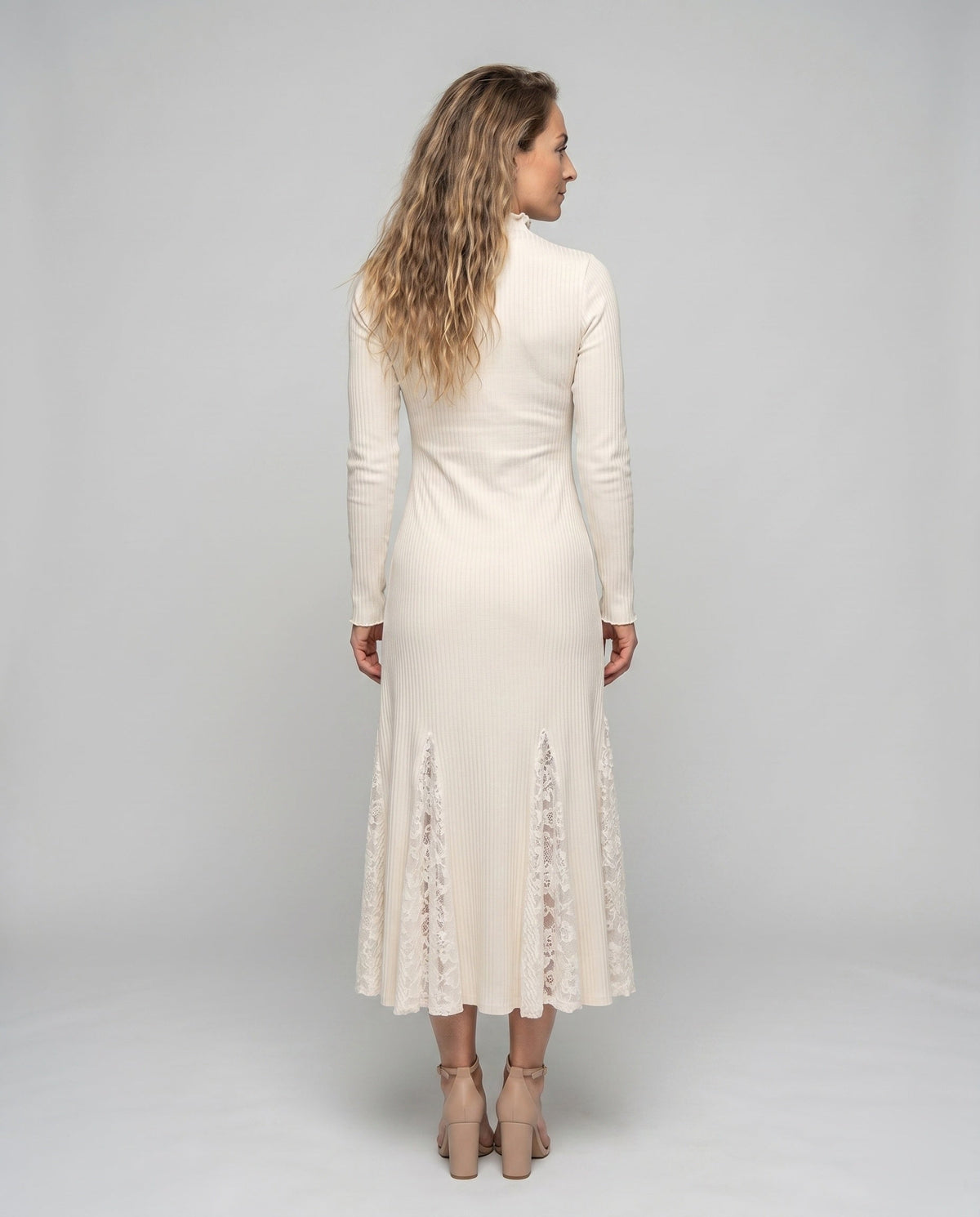 Women’s dress with sophisticated lace accents and elegant pleat design - back view