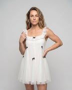 Women's dress with playful ruffles and delicate bow details - upper body view