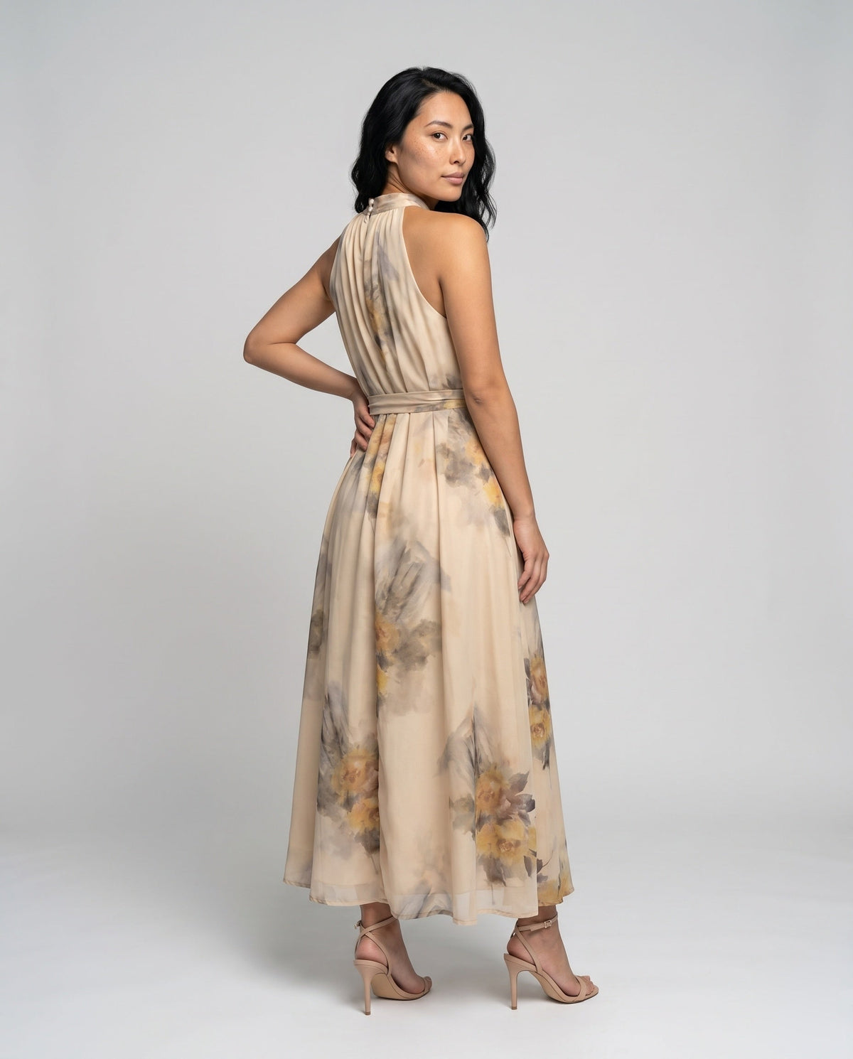 Women's maxi dress with floral accents and elegant halter neckline - back view