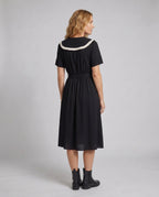 Women’s midi dress with contrasting ruffle details and fitted silhouette - back view