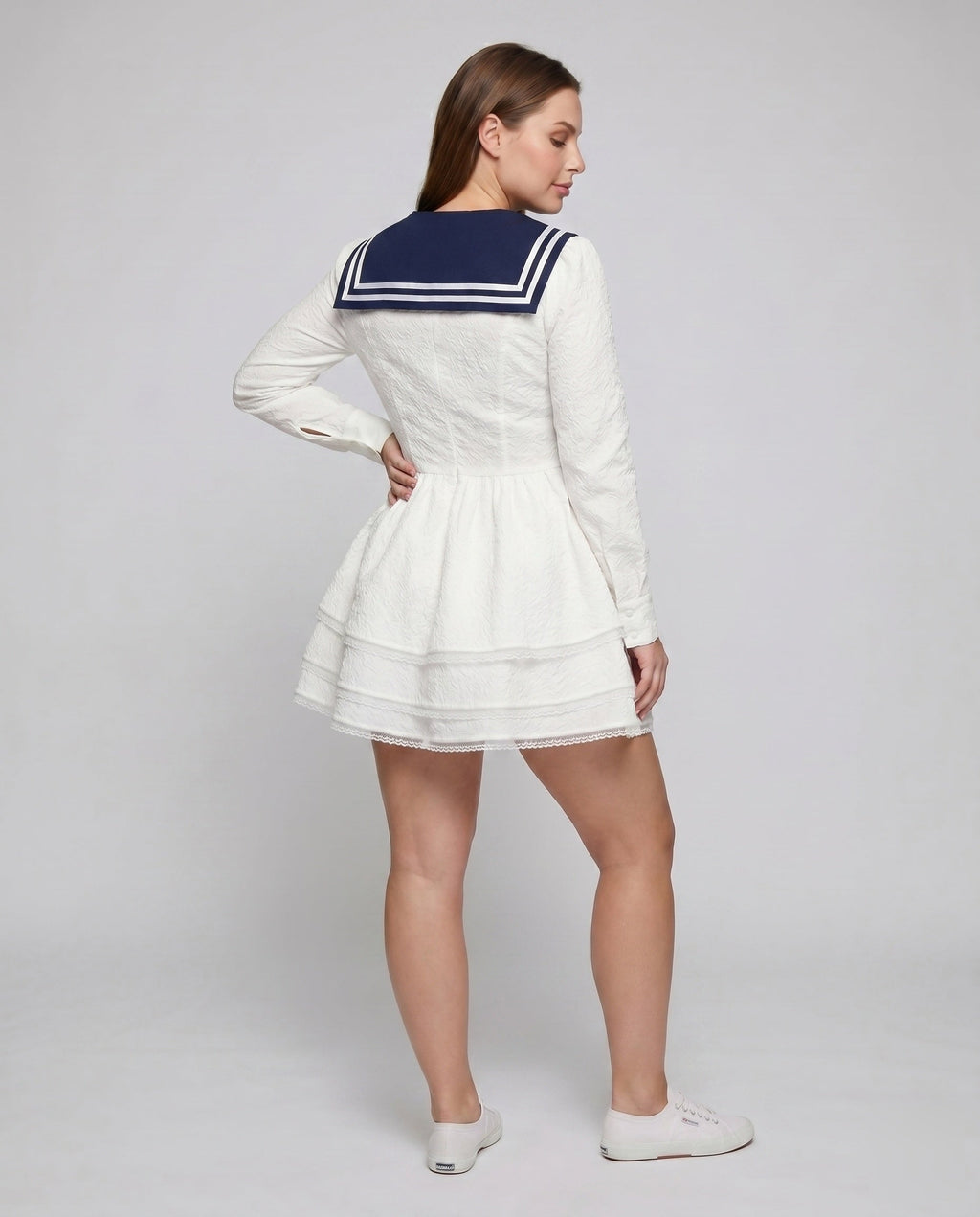 Women's nautical-inspired mini dress with wide skirt and continuous ruffle hem - back view